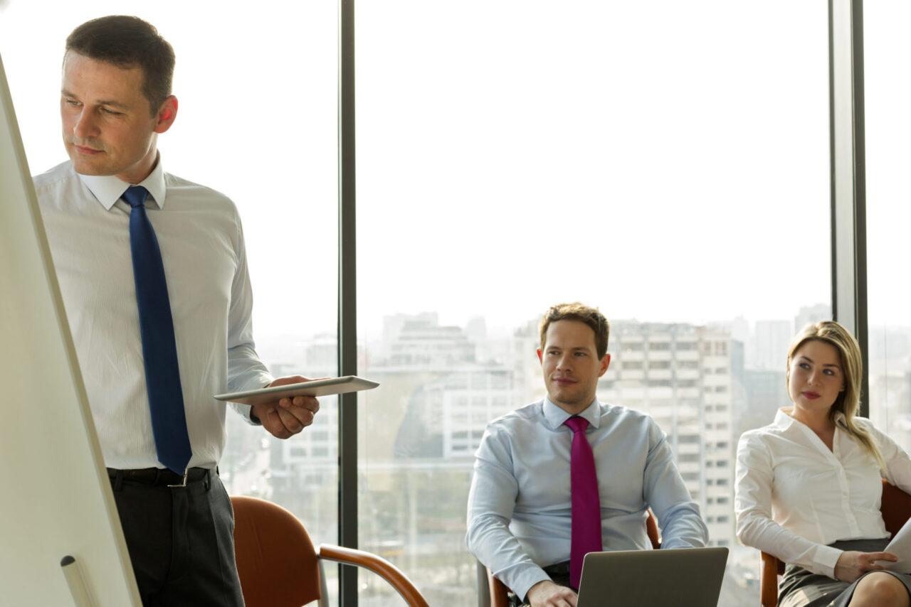 Businessman at flip chart leading a seminar