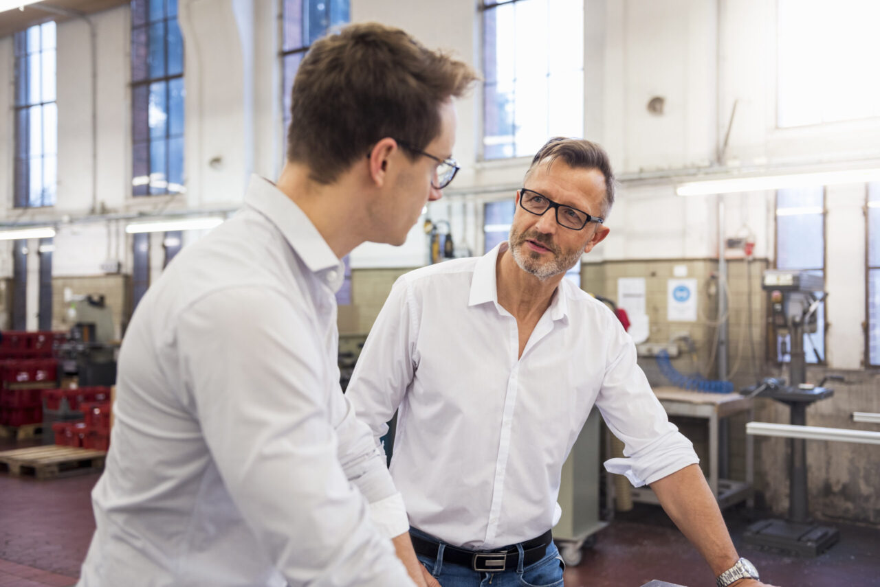 Two businessmen discussing in factory