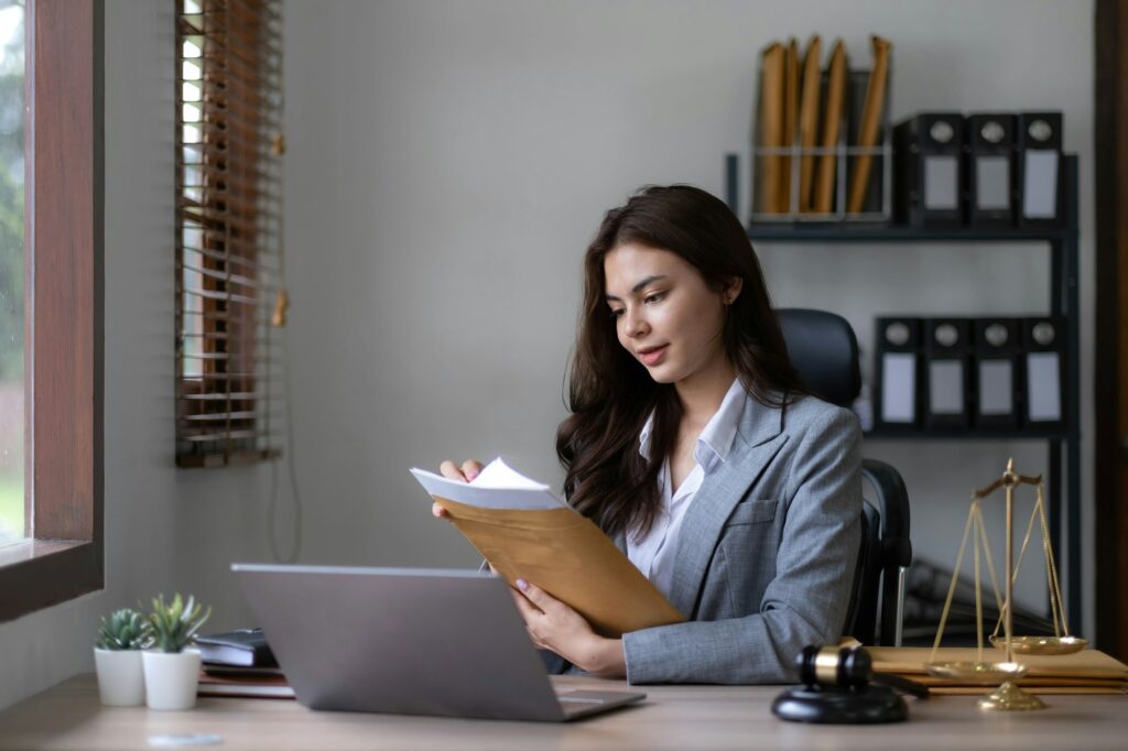 Asian lawyer woman working with a laptop computer in a law office. Legal and legal service concept.