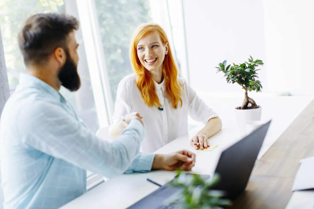 Business people shaking hands and finishing up a meeting