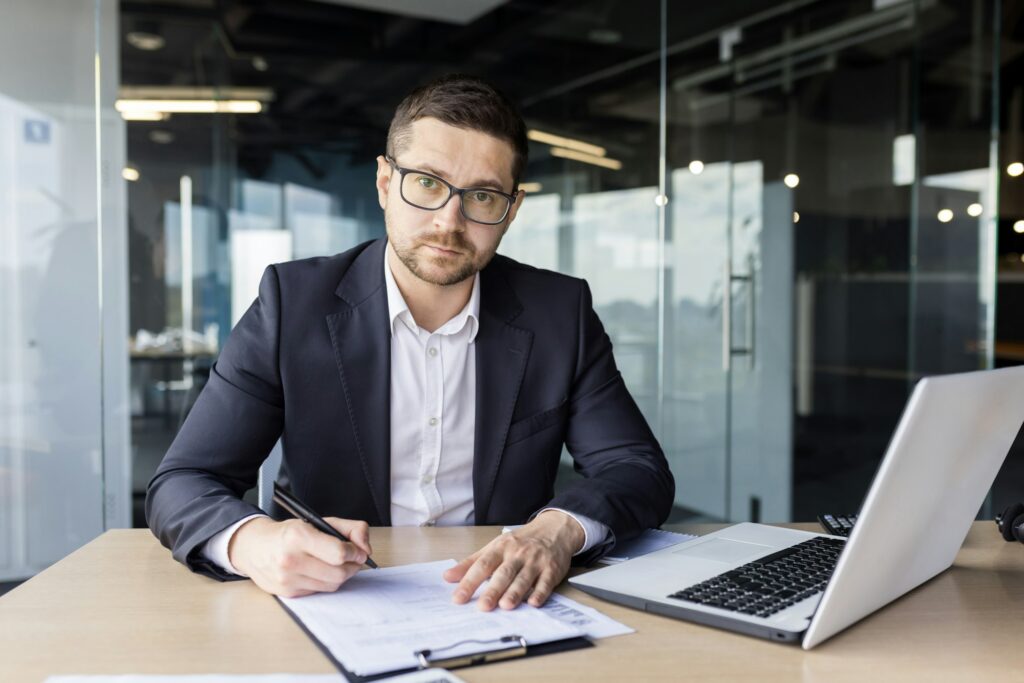 Portrait of a young lawyer. a notary who is concentrating on working in the office with a laptop