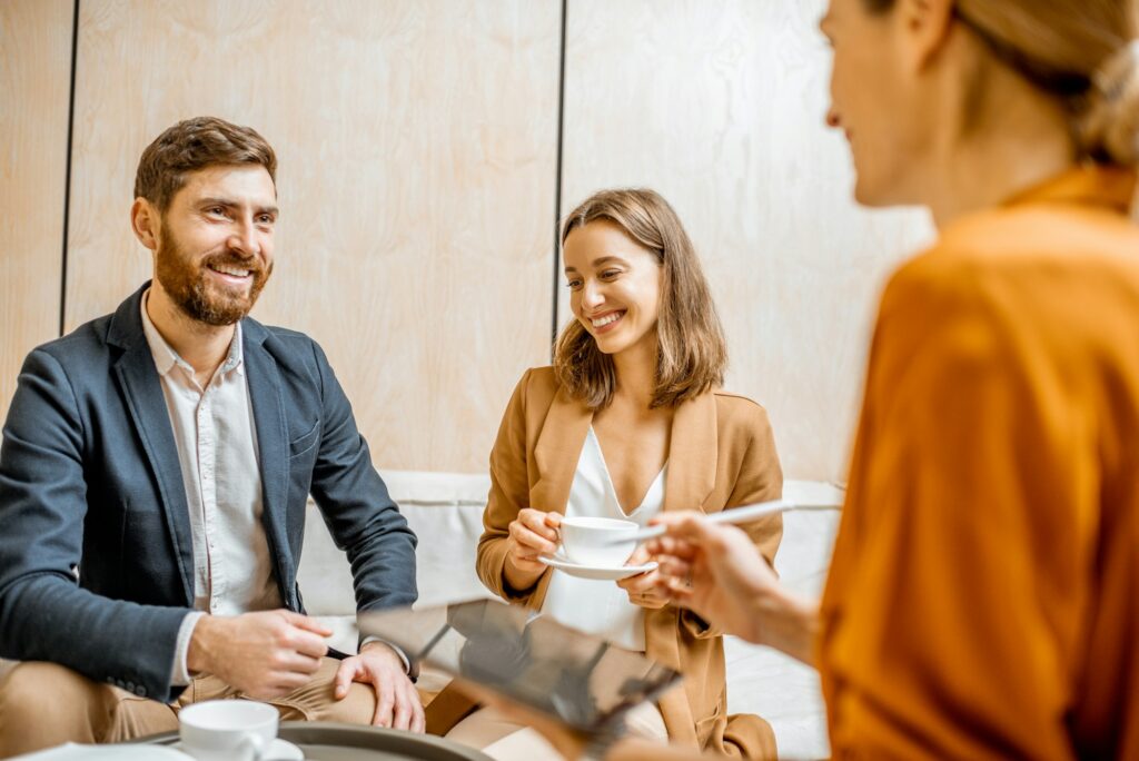 Young couple with sales manager in the office